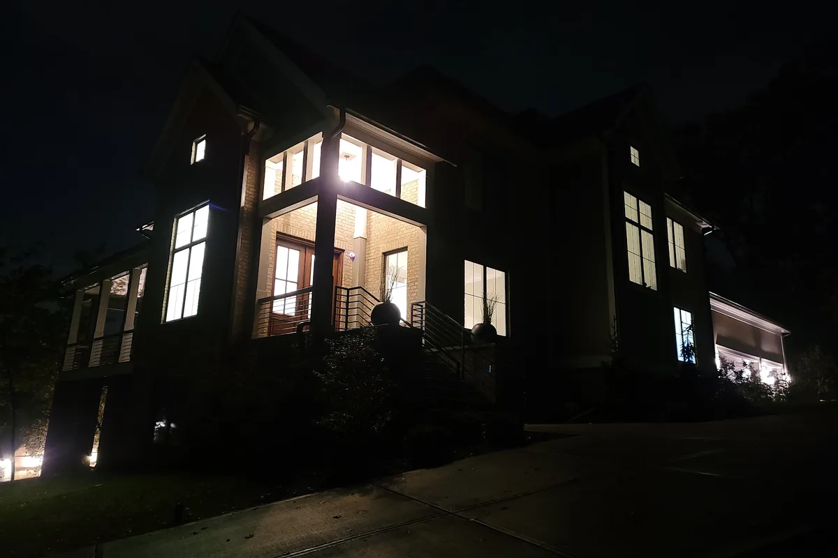 Before: modern Indianapolis home at night with no exterior lighting installed