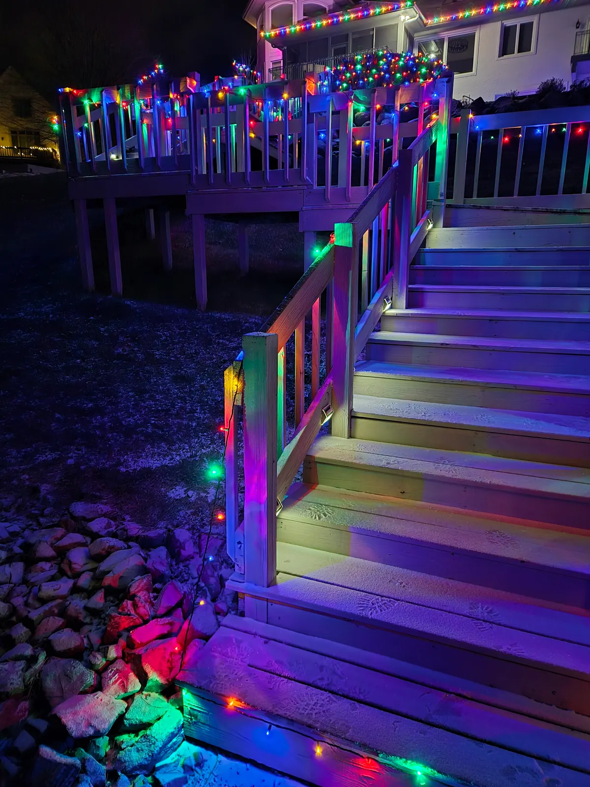 Custom wrapped shrubbery with dense multicolor Christmas bulb lighting