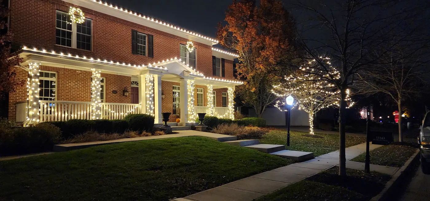 Multicolor programmable permanent lighting on a two-story brick home